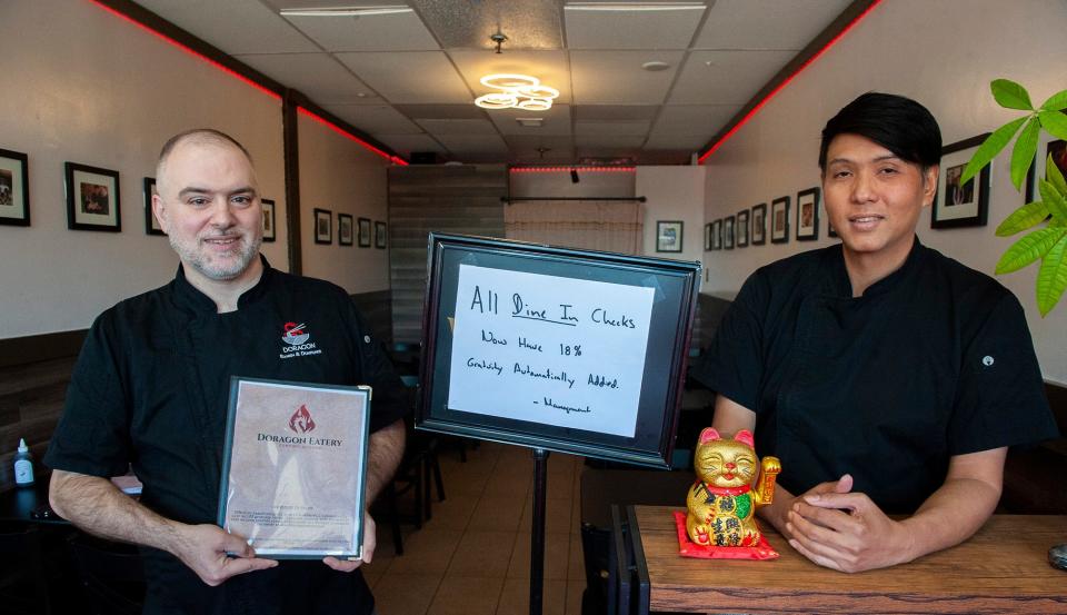 Doragon Eatery partners Alan and Paponake MacIntosh inside their Ashland restaurant, May 10, 2024. The restaurant has instituted a new 18% gratuity on all of its dine-in orders. Alan MacIntosh said low tips have led to high turnover in the server staff.