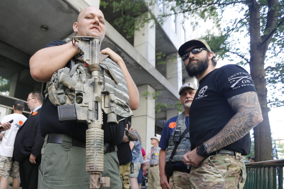 Gun rights supporters hold weapons outside the Capitol office building at the State Capitol in Richmond, Va., Tuesday, July 9, 2019. Governor Northam called a special session of the General Assembly to consider gun legislation in light of the Virginia Beach Shootings. (AP Photo/Steve Helber)