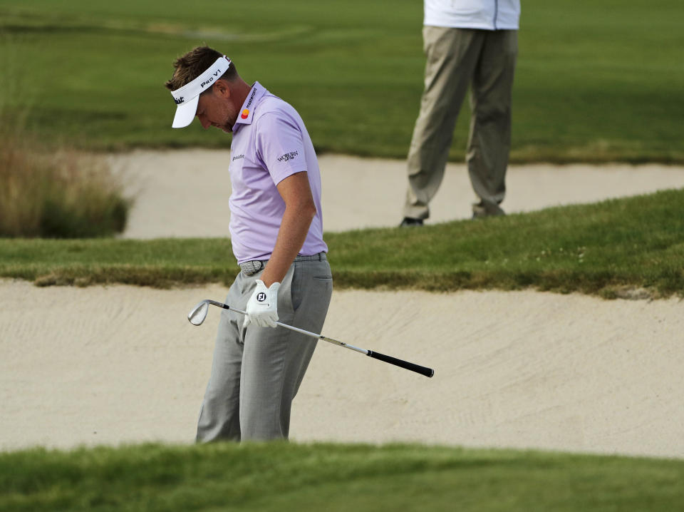 Ian Poulter, of England, reacts after a shot out of the bunker on the ninth hole during the second round of the U.S. Open Golf Championship. (AP)