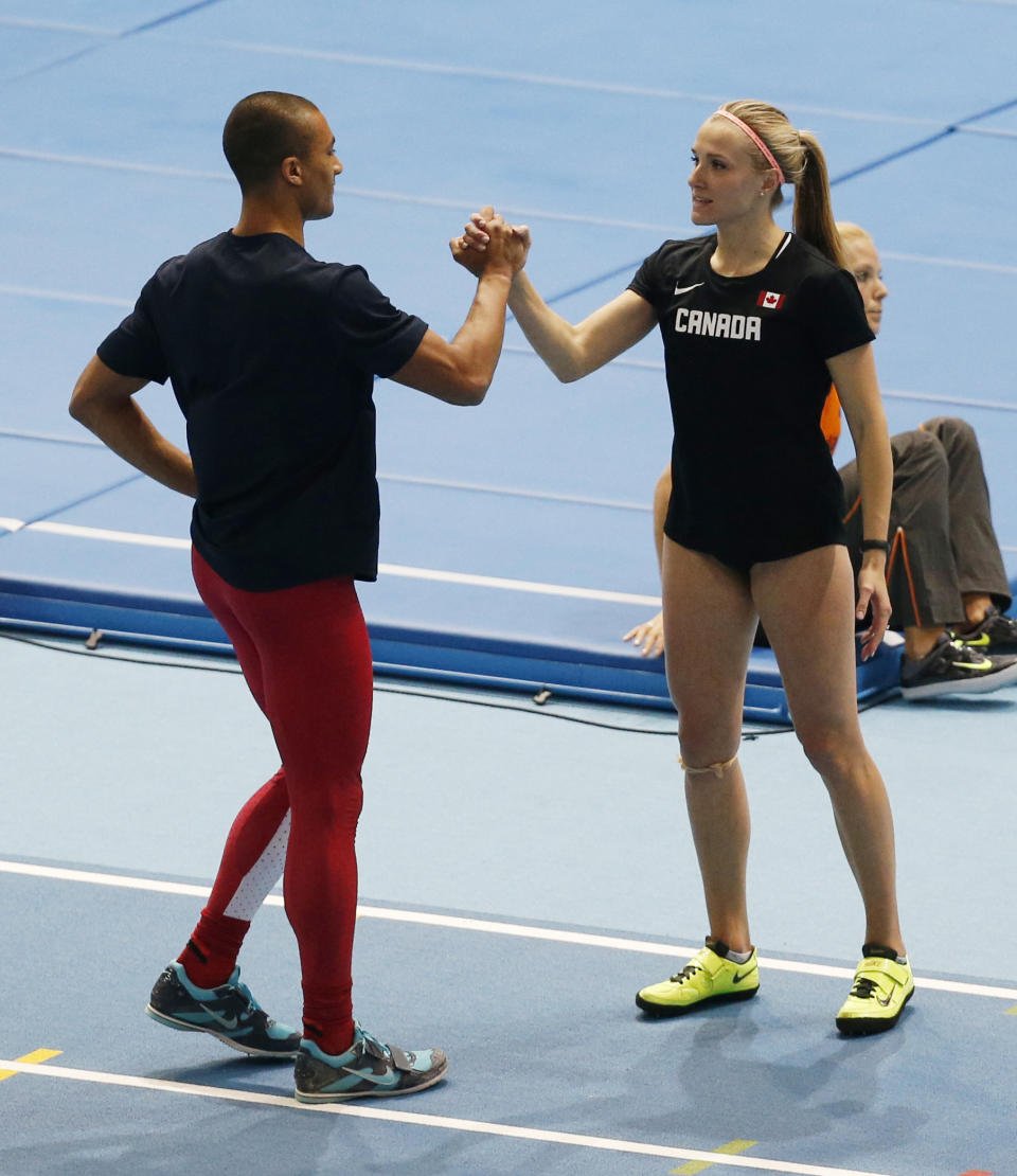 United States' Ashton Eaton, left, and his wife Canada's Brianne Theisen Eaton stand together during the Athletics World Indoor Championships in Sopot, Poland, Friday, March 7, 2014. (AP Photo/Petr David Josek)