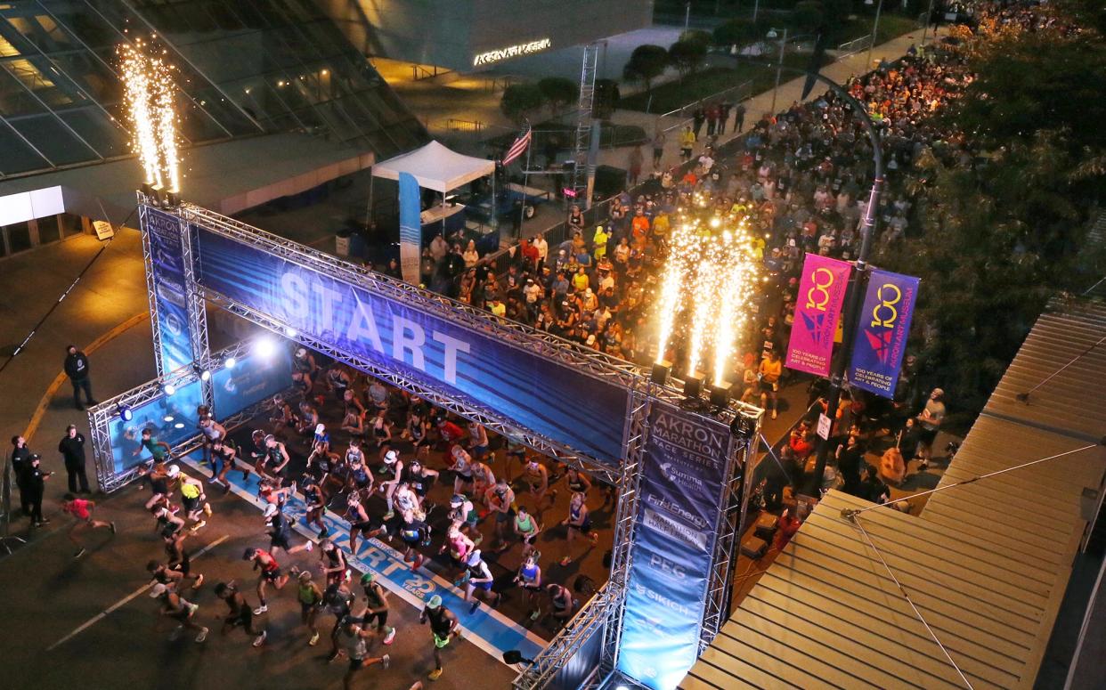 Runners stream across the starting line in front of the Akron Art Museum at the 20th Akron Marathon on Saturday.