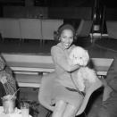 <p>Actress Dorothy Dandridge gives her dog a great hug at Orly Airport in Paris. It's unknown if this was her beloved pup, Cissi. </p>