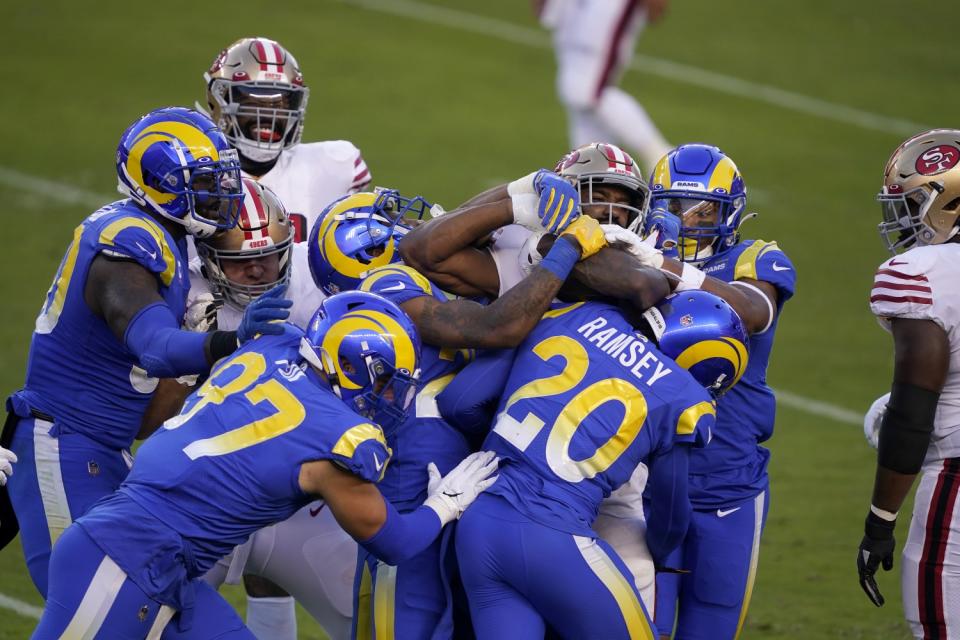 San Francisco's Raheem Moster is tackled by a slew of Ram defenders during their battle won by the 49ers on Oct. 18.