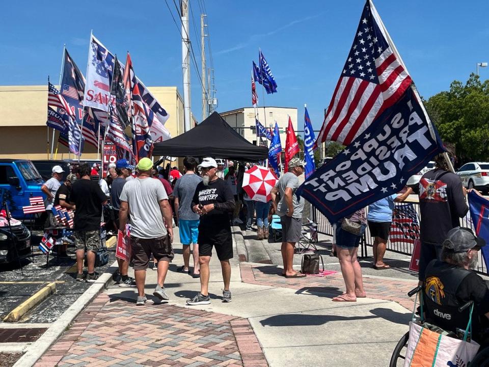 A crowd for former President Donald Trump gathers on Thursday, March 14, 2024, behind the Alto Lee Adams Sr. U.S. courthouse in Fort Pierce. Black tents are set up for crowds with media crews sitting under the tents too.