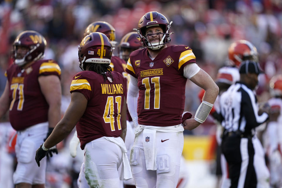 Washington Commanders quarterback Carson Wentz (11) looks at the scoreboard during the second half of an NFL football game against the Cleveland Browns, Sunday, Jan. 1, 2023, in Landover, Md. (AP Photo/Patrick Semansky)