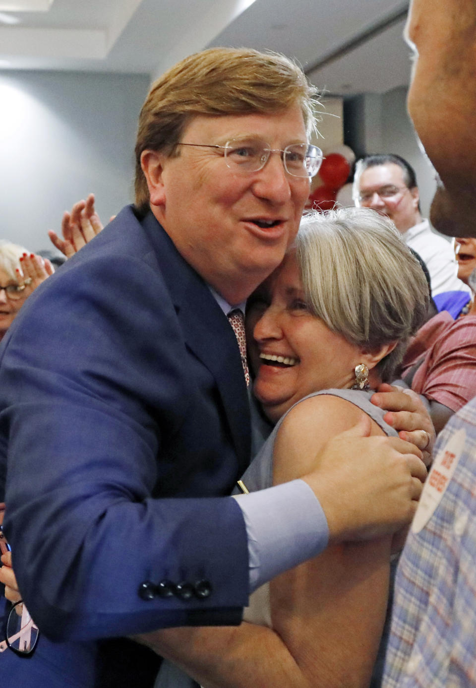 Republican Lt. Gov. Tate Reeves, a gubernatorial candidate, left, is congratulated by a supporter at his election watch party in Flowood, Miss., Tuesday, Aug. 6, 2019. Reeves was in the lead of his party primary. (AP Photo/Rogelio V. Solis)