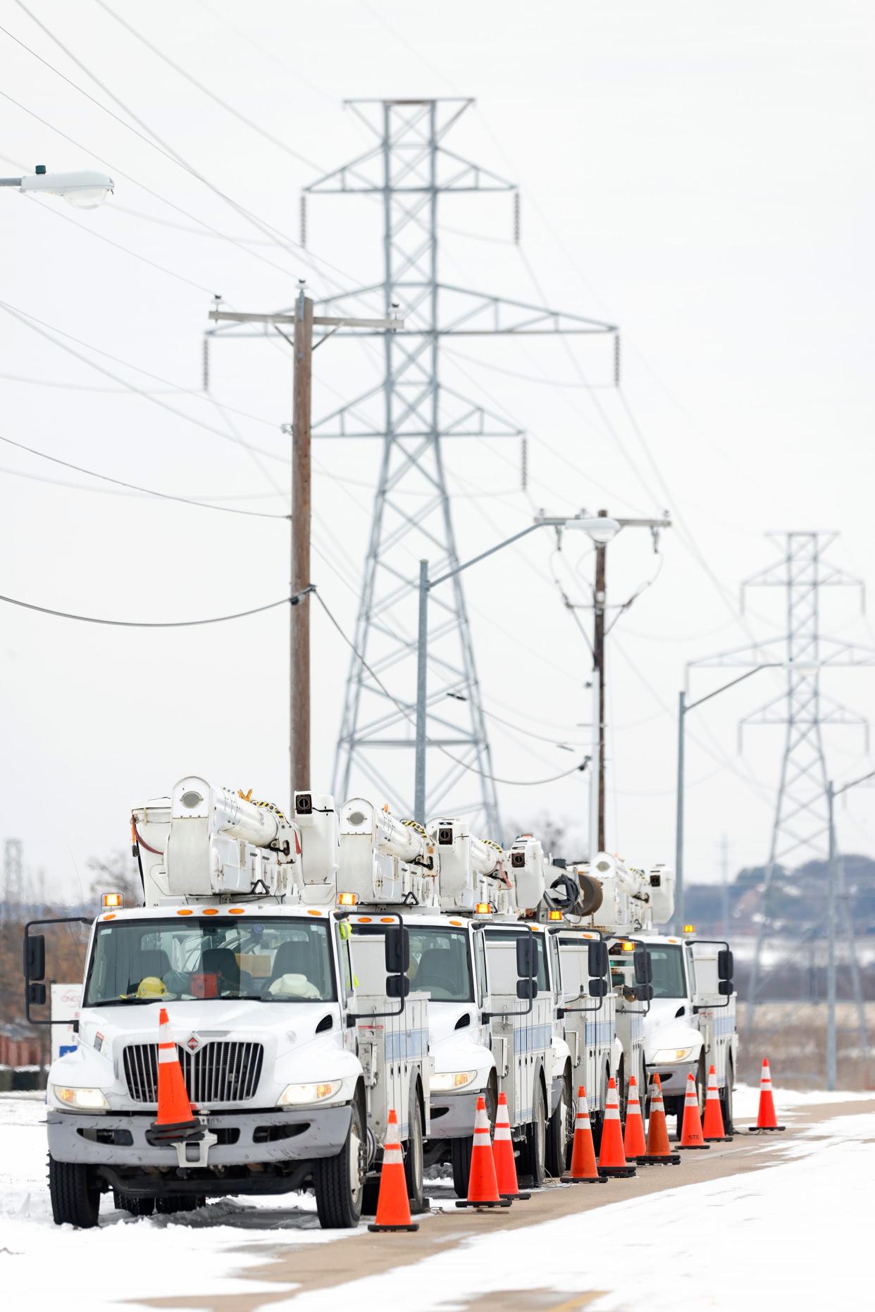 Electric service trucks line up in Fort Worth, Texas, after a snow storm during Winter Storm Uri. Uri brought historic cold weather as storms swept across 26 states with a mix of freezing temperatures and precipitation.