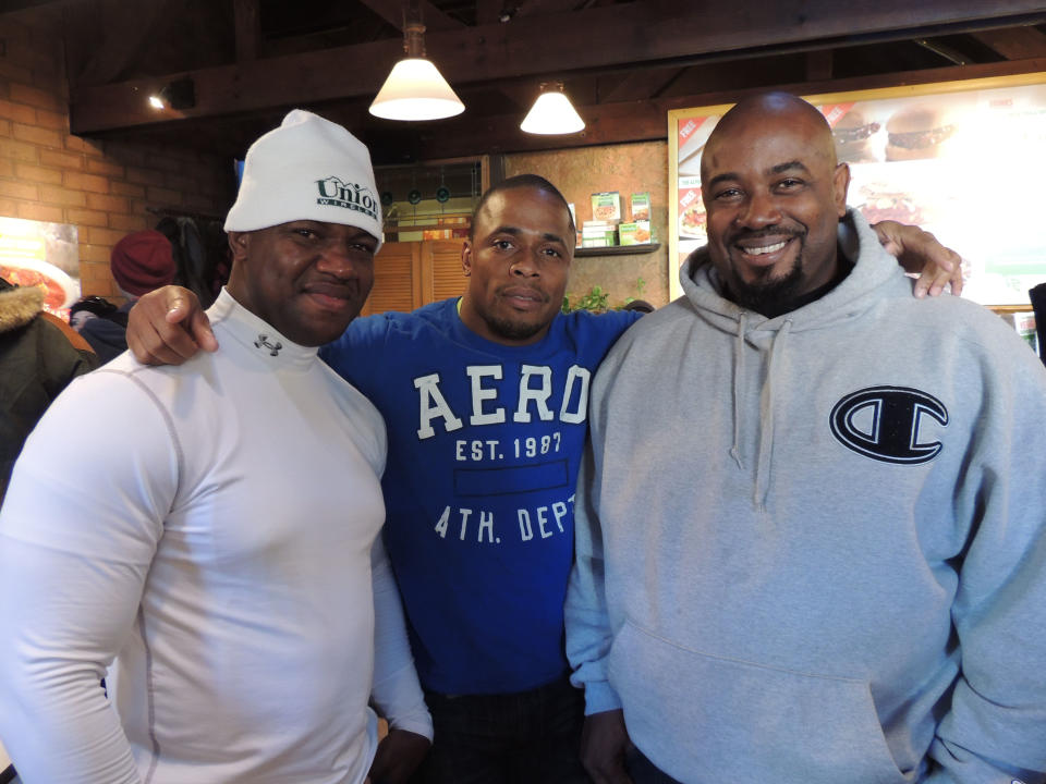 From left, Jamaican bobsled team members Wayne Blackwood, Marvin Dixon and coach Wayne Thomas pose at the MorningStar Veggie Burger Bar in Park City, Utah, on Monday, Jan. 20, 2014, as the team, bound for the Winter Olympics in Sochi, Russia, arrives at the Sundance Film Festival to raise funds for travel and equipment for their Olympic quest. (AP Photo/Nekesa Mumbi Moody)