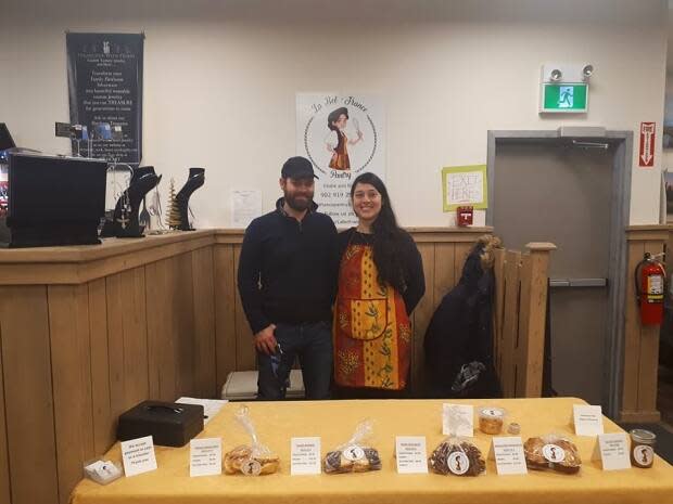 Elodie Nasone and her partner, Bart Pennewaert, are shown at their stall inside the Cape Breton Farmers' Market in Sydney. Due to COVID-19 restrictions, the regular Saturday market is now closed. 