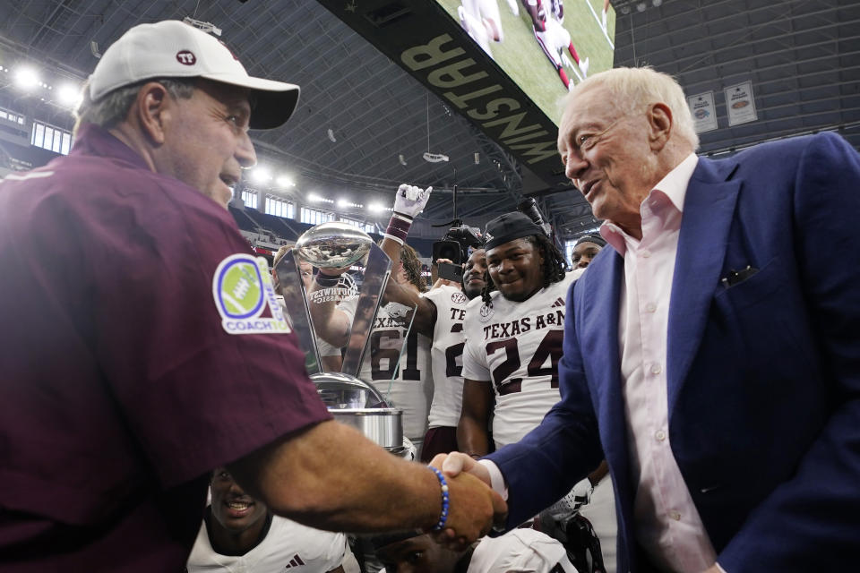 Dallas Cowboys owner Jerry Jones, right, shakes hands with Texas A&M head coach Jimbo Fisher after an NCAA college football game against Arkansas, Saturday, Sept. 30, 2023, in Arlington, Texas. (AP Photo/LM Otero)