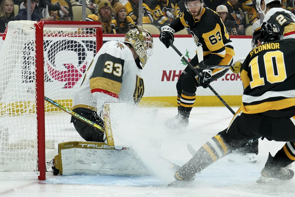 Vegas Golden Knights goaltender Adin Hill (33) makes a save on Pittsburgh Penguins' Drew O'Connor (10) during the second period of an NHL hockey game, Sunday, Nov. 19, 2023, in Pittsburgh. (AP Photo/Matt Freed)