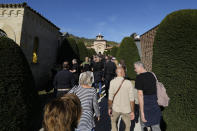 People queue to visit the crypt of former dictator Benito Mussolini at the San Cassiano cemetery, to mark the 100th anniversary of the coup d'etat by which he sized power in 1922, in Predappio, Italy, Sunday, Oct. 30, 2022. (AP Photo/Luca Bruno)