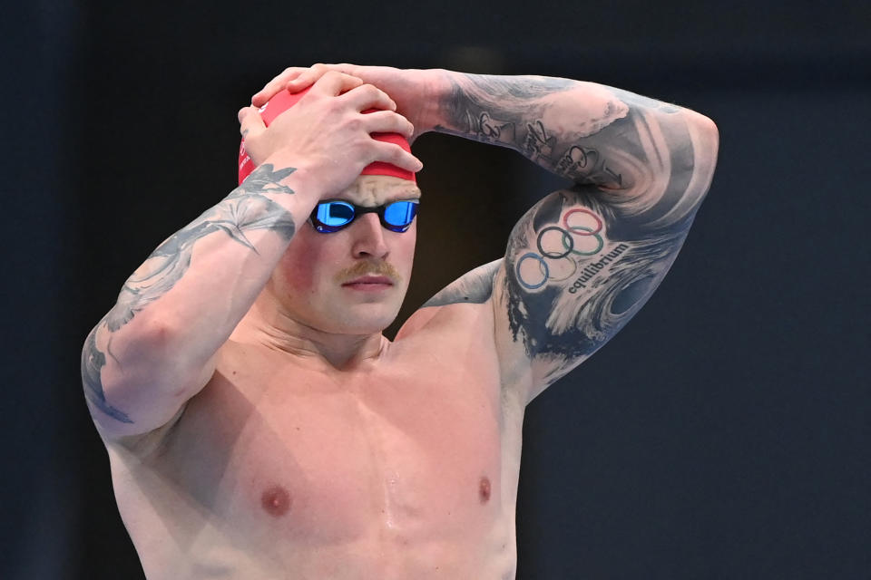 <p>Britain's Adam Peaty prepares to compete in a heat for the men's 100m breaststroke swimming event during the Tokyo 2020 Olympic Games at the Tokyo Aquatics Centre in Tokyo on July 24, 2021. (Photo by Attila KISBENEDEK / AFP) (Photo by ATTILA KISBENEDEK/AFP via Getty Images)</p> 