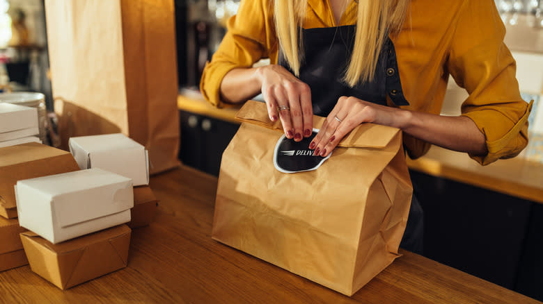 woman boxing up to-go food