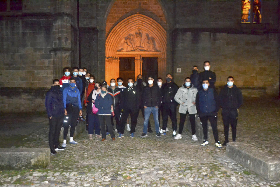 This photo take on Oct. 29, 2020 shows a group of Muslim volunteers protecting the Saint-Fulcran cathedral In Lodeve, southern France. A group of French Muslims stood guard outside the Saint-Fulcran Cathedral in Lodeve for the All Saints' holiday, to protect it from eventual violence and show solidarity with Catholic churchgoers. Many welcomed the initiative, organized by local residents as a gesture of peace after a deadly Islamic extremist attack on a church in the French city of Nice. (Alain Mendez via AP)