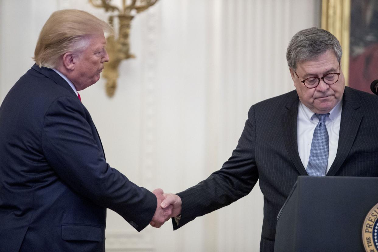 Then-President Donald Trump (left) shakes hands with then-U.S. Attorney General William Barr (right) in the East Room of the White House in Washington, D.C. on Sept. 9, 2019.