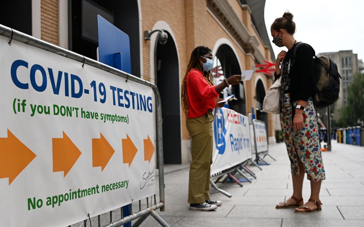 A person waits outside a Covid-19 testing centre in London on 26 July 2021 - Andy Rain/Shutterstock