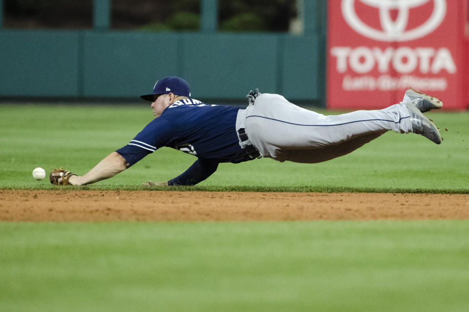 San Diego Padres' Ty France misses a ball hit by Philadelphia Phillies' Jean Segura during the sixth inning of a baseball game Friday, Aug. 16, 2019, in Philadelphia. (AP Photo/Matt Rourke)