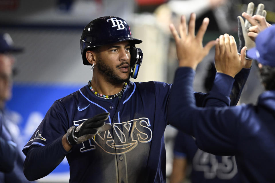 Tampa Bay Rays' Jose Siri is congratulated after scoring against the Los Angeles Angels during the fourth inning of a baseball game in Anaheim, Calif., Tuesday, April 9, 2024. (AP Photo/Alex Gallardo)