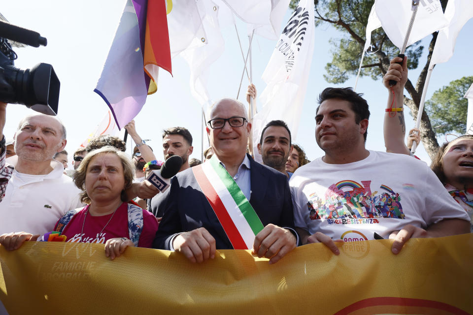 Rome Mayor Roberto Gualtieri, wearing the three color band of the Italian flag, joins the LGBTQ+ Pride parade in Rome, Saturday, June 10, 2023. Rome's annual LGBTQ+ Pride parade is winding its way through the Italian capital. This year's version provides a counterpoint to the right-wing national government's crackdown on surrogate pregnancies. Earlier this year, the government headed by far-right Premier Giorgia Meloni told municipal officials to refrain from recording both members of a same-sex couple as the parent of the child, only the biological parent. Among those who have defied that order was center-left Rome Mayor Roberto Gualtieri, who came to Saturday's parade. (Cecilia Fabiano/LaPresse via AP)