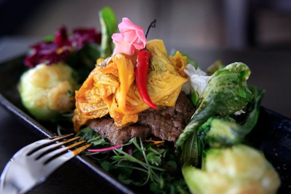 A wagyu beef dish with bok choy and kimchi is among the signature offerings at Pink Salt Restaurant + Veveta Tapas, also known as Vevetas Tapas by Pink Salt, in the Lakewood neighborhood of Jacksonville.