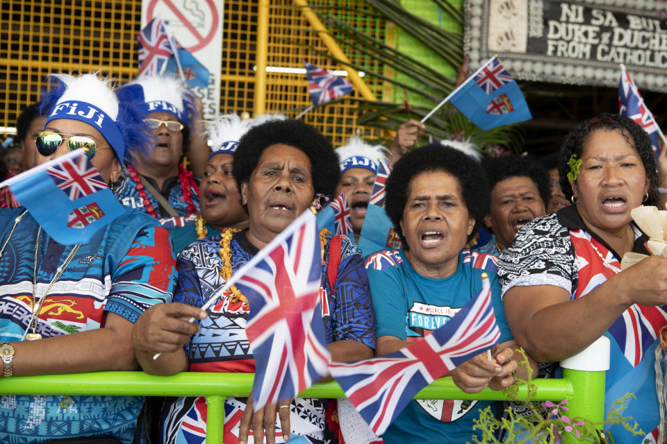 Local Fijian women wait for the arrival of Meghan, Duchess of Sussex at a market in Suva, Fiji, Wednesday, Oct. 24, 2018. Prince Harry and his wife Meghan are on day nine of their 16-day tour of Australia and the South Pacific. (Ian Vogler/Pool Photo via AP)