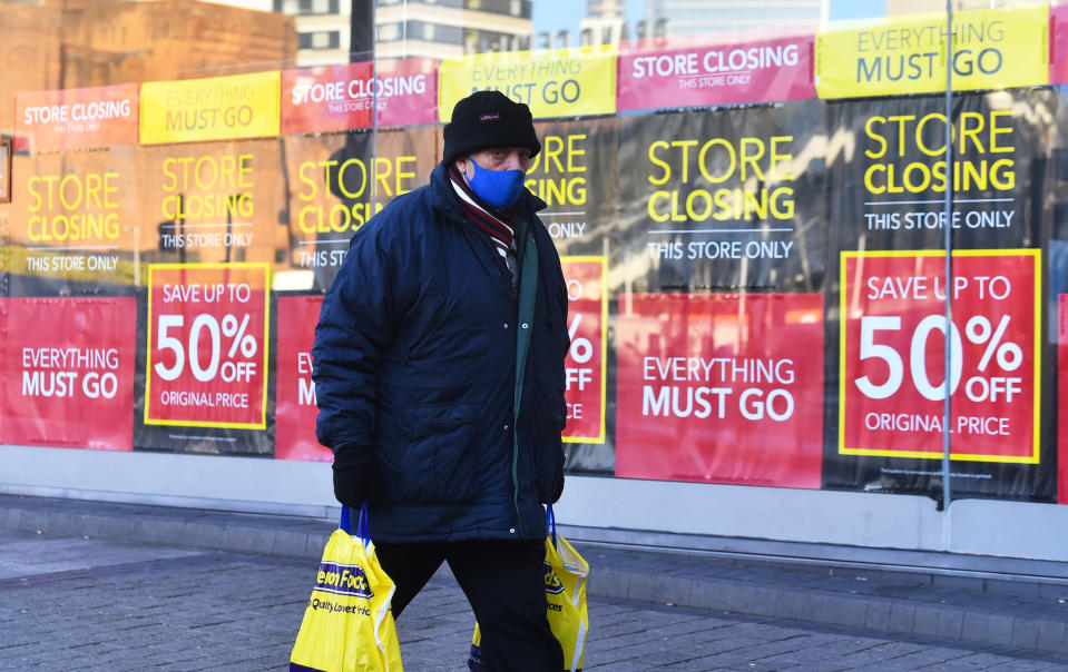 BIRMINGHAM, ENGLAND - JANUARY 05: : A man wearing a mask walks past a closing down sign in Birmingham during the nationwide lockdown on January 05, 2021 in Birmingham, England. British Prime Minister made a national television address on Monday evening  announcing England is to enter its third coronavirus lockdown of the year. On Monday the UK recorded more than 50,000 new confirmed Covid cases for the seventh day in a row. (Photo by Nathan Stirk/Getty Images)