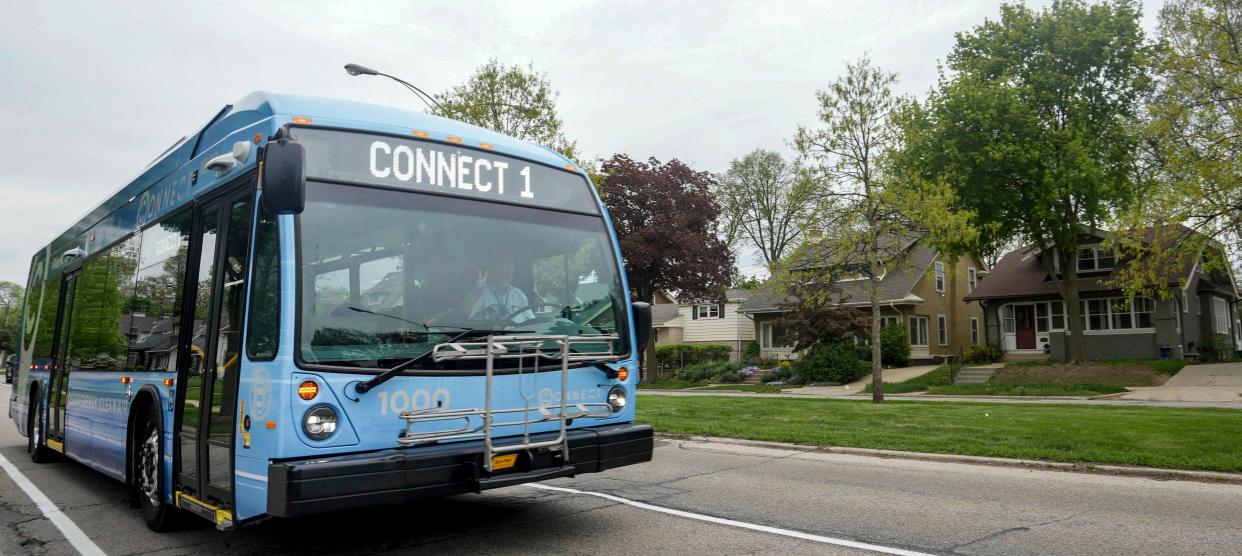 The new Milwaukee County Transit System electric bus  travels down the 'bus only' lane in the new bus route on Wisconsin Ave.