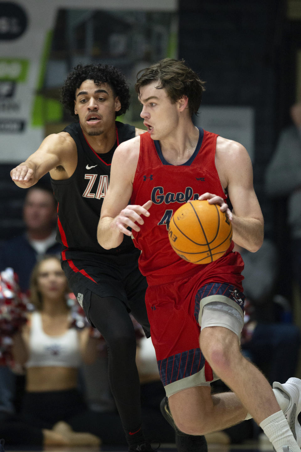 Saint Mary's guard Alex Ducas, right, drives around Gonzaga guard Julian Strawther, left, during the first half of an NCAA college basketball game, Saturday, Feb. 4, 2023, in Moraga, Calif. (AP Photo/D. Ross Cameron)