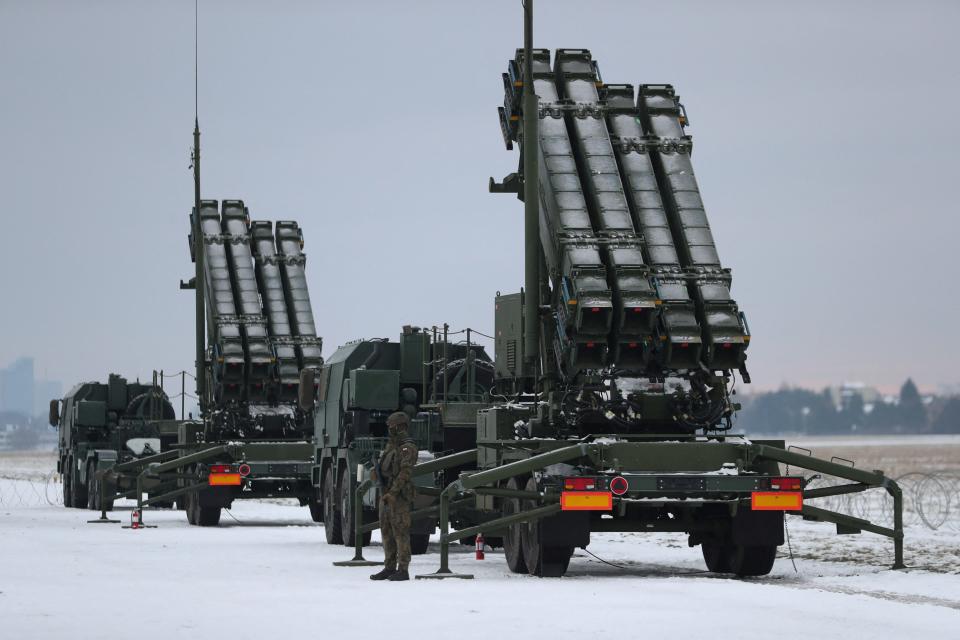 Serviceman patrols in front of the Patriot air defence system during Polish military training on the missile systems at the airport in Warsaw, Poland February 7, 2023.