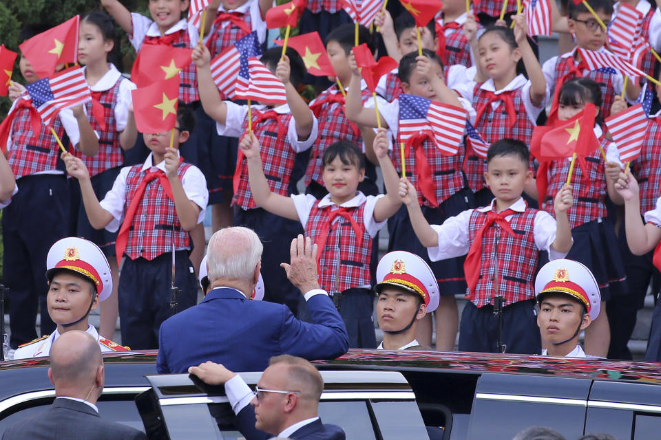 US President Joe Biden waves to the children after a military welcome ceremony at the Presidential Palace in Hanoi, Vietnam, Sunday, Sept.10, 2023. Biden is on an official two-day visit in Vietnam. (Luong Thai Linh/Pool Photo via AP)