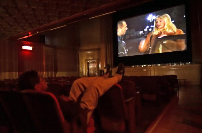 A man watches an XXX rated movie at the Hollywood cinema in Quito, on March 6, 2015, one of two porno cinemas in the capital which have survived the Internet thanks to a handful of steadfast customers