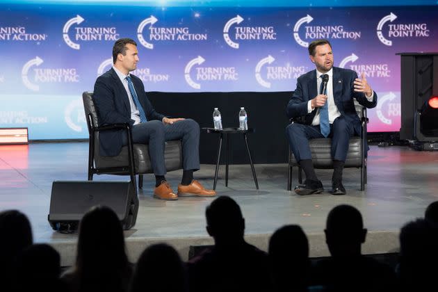 Right-wing podcast host Charlie Kirk interviews Republican vice presidential candidate J.D. Vance during a campaign rally Wednesday in Mesa, Arizona.