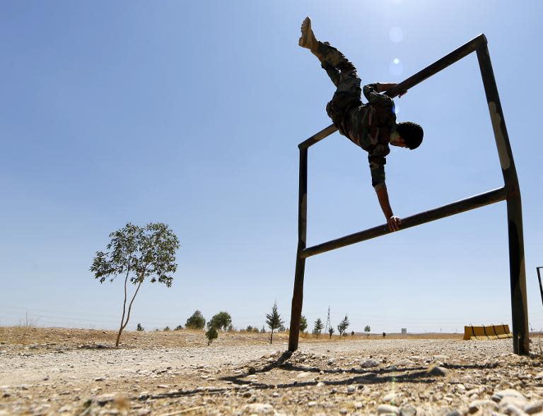 Iraqi Kurdish Peshmerga fighters take part in a training session in the grounds of their camp on June 23, 2014 in Arbil, the capital of the autonomous Kurdish region of northern Iraq