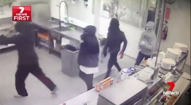 A terrified staff member locks himself in a safe room as 10 masked youths ransack the service station and smash up everything in sight. Picture: 7 News