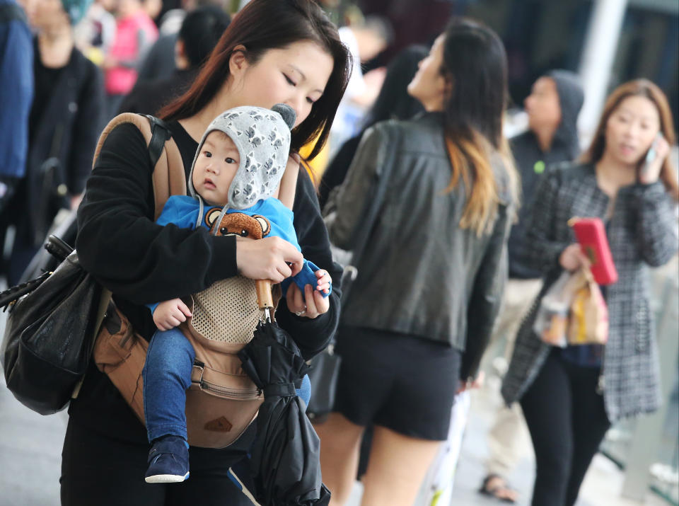 A mother and her baby with thick clothing seen on the street in Tsim Sha Tsui as cold weather hits Hong Kong. 23NOV16 SCMP / K. Y. Cheng (Photo by K. Y. Cheng/South China Morning Post via Getty Images)