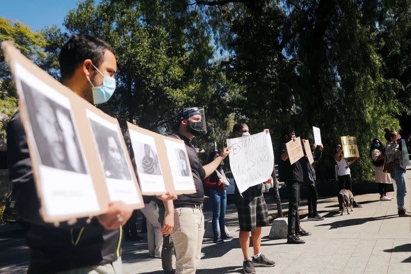 Cuban students living in Mexico and other demonstrators protest outside the Cuban Embassy in Mexico City