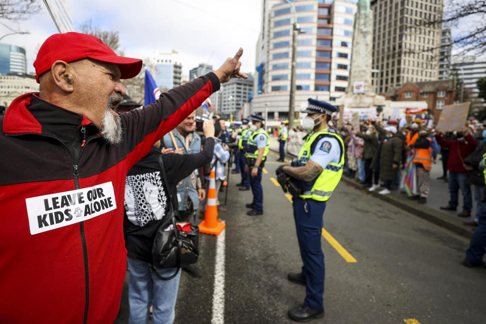 Freedom and Rights Coalition protesters demonstrate outside Parliament in Wellington, New Zealand, Tuesday, Aug. 23, 2022. About 2,000 protesters upset with the government's pandemic response converged on New Zealand's Parliament — but it appeared there would be no repeat of the action six months ago in which protesters camped out on Parliament grounds for more than three weeks. (George Heard/New Zealand Herald via AP)