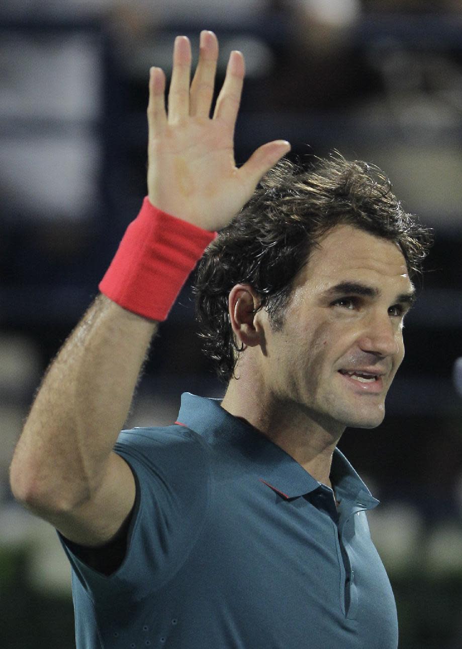 Roger Federer of Switzerland celebrates after he beat Radek Stepanek of the Czech Republic during the third day of the Dubai Duty Free Tennis Championships in Dubai, United Arab Emirates, Wednesday, Feb. 26, 2014. (AP Photo/Kamran Jebreili)