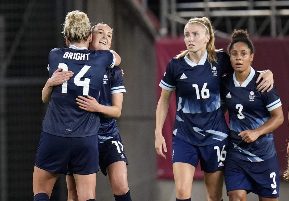 Britain's Caroline Weir, 2nd left, celebrates with teammate Millie Bright after scoring her side's opening goal against Canada during a women's soccer match at the 2020 Summer Olympics, Tuesday, July 27, 2021, in Kashima, Japan. (AP Photo/Fernando Vergara)