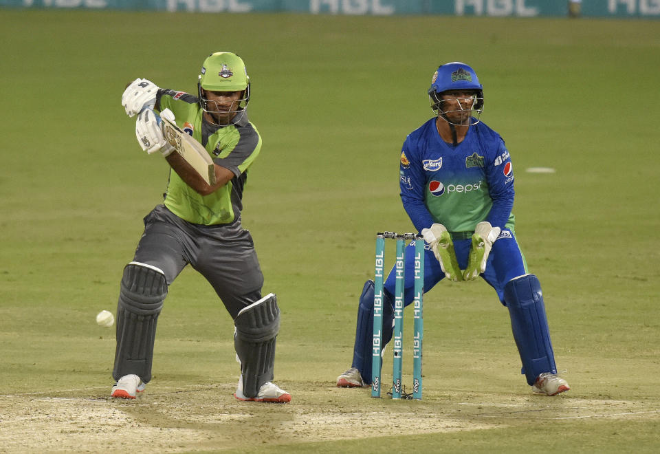 Lahore Qalandars batsman Fakhar Zaman, left, plays a shot while Multan Sultans wicketkeeper Zeeshan Ashraf watches during the second eliminator cricket match of Pakistan Super League T20 cup at National Stadium in Karachi, Pakistan, Sunday, Nov. 15, 2020. (AP Photo/Fareed Khan)