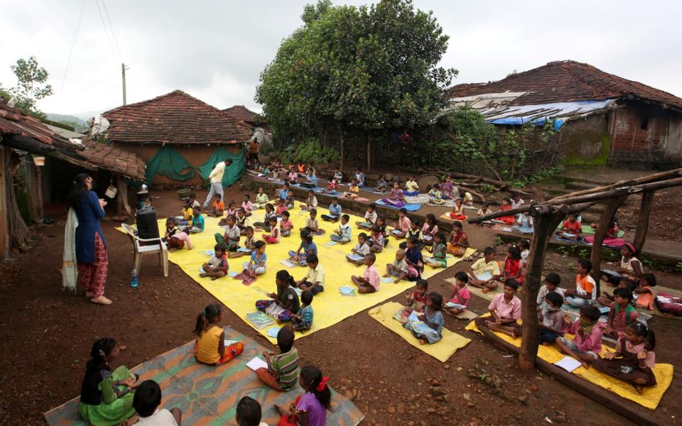 Schoolchildren learn with the help of pre-recorded lessons in Dandwal village, Maharashtra, India  - REUTERS/Prashant Waydande