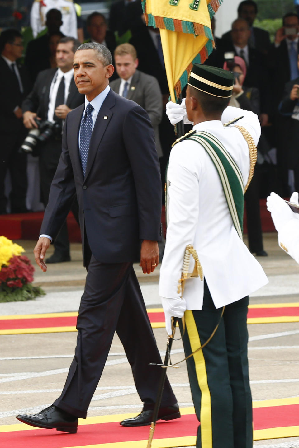 U.S. President Barack Obama, left, walks after a welcome ceremony at Parliament Square in Kuala Lumpur, Malaysia, Saturday, April 26, 2014. (AP Photo/Vincent Thian)