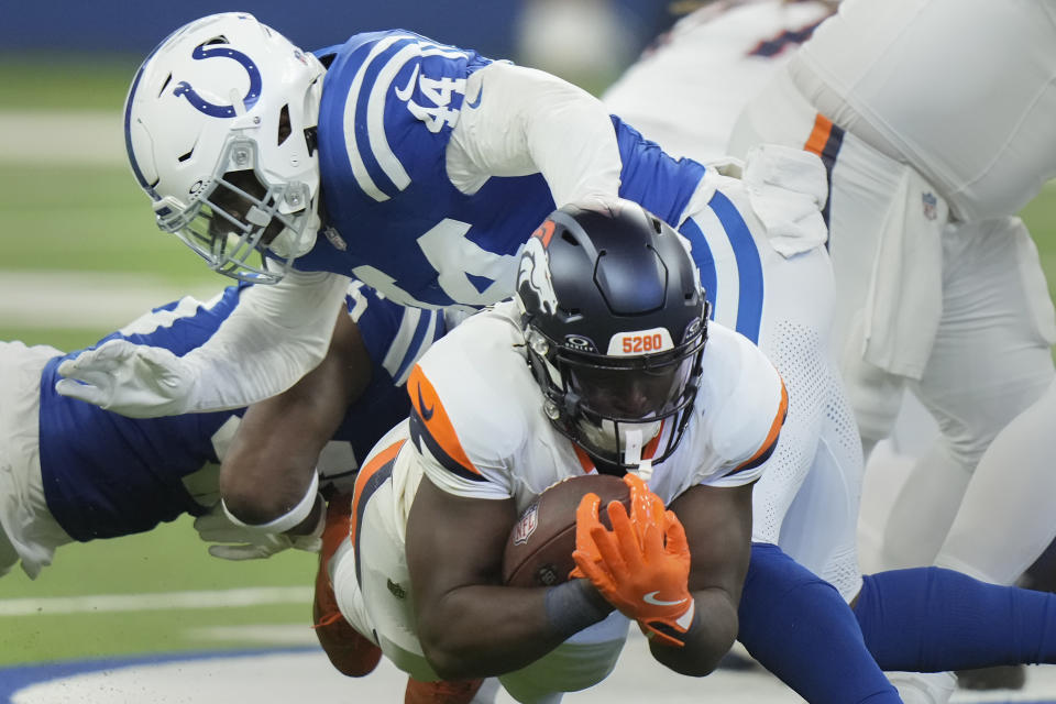 Denver Broncos running back Javonte Williams (33) is tackled by Indianapolis Colts linebacker Zaire Franklin (44) during the first quarter of a preseason NFL football game, Sunday, Aug. 11, 2024, in Westfield, Ind. (AP Photo/AJ Mast)