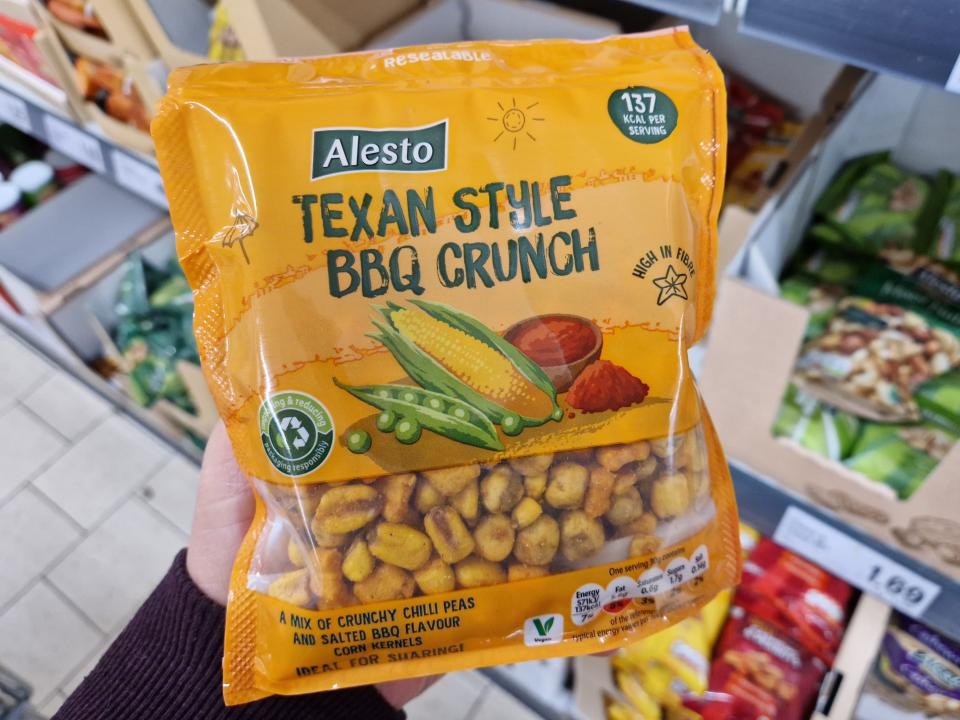 The writer holds Alesto Texan-style BBQ crunch snack