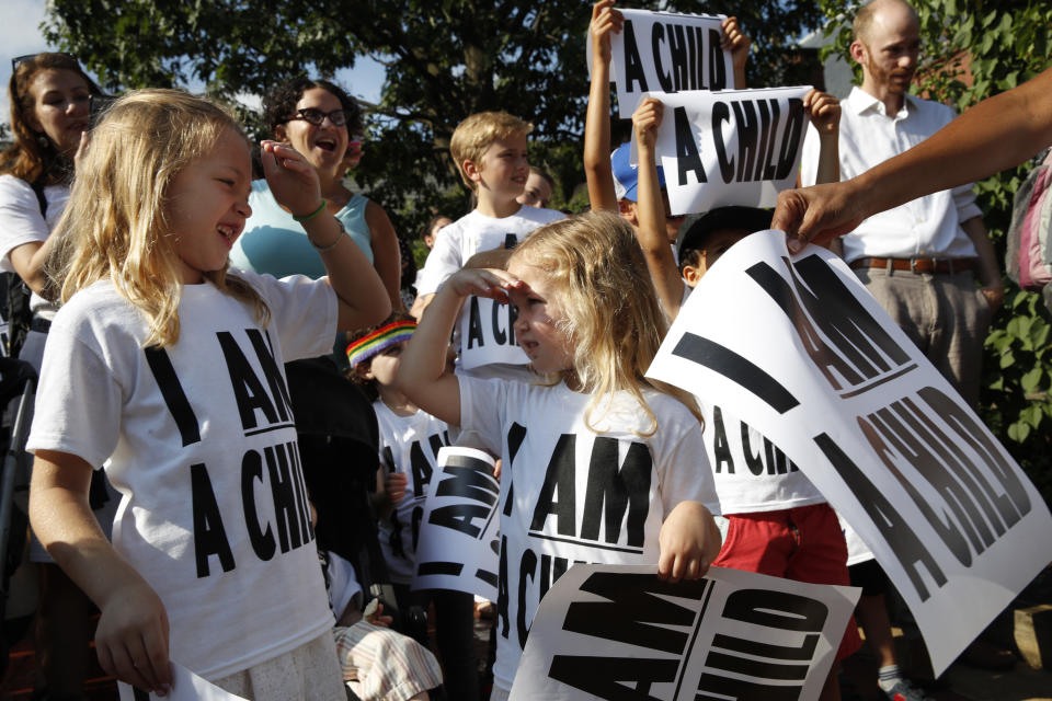 Billie Himmelan, 7, left, talks with her sister Joni Himmelman, 4, of Washington, as families gathered to march in a protest demanding the reunification of separated immigrant families, Thursday, July 26, 2018, on Capitol Hill in Washington. The Trump administration faces a court-imposed deadline Thursday to reunite thousands of children and parents who were forcibly separated at the U.S.-Mexico border, an enormous logistical task brought on by its "zero tolerance" policy on illegal entry. (AP Photo/Jacquelyn Martin)