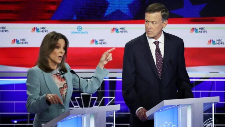 Marianne Williamson (left) speaks as former Colorado Gov. John Hickenlooper looks on during the second night of the first Democratic presidential debate on June 27, 2019 in Miami. Williamson said problems she addressed four years ago are still true as she runs again, (Photo: Drew Angerer/Getty Images)