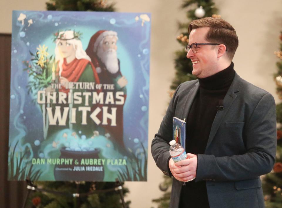 Dan Murphy greets the crowd as he enters a book reading and signing with collaborator Aubrey Plaza for their "The Return of the Christmas Witch" at Rockwood Museum, Thursday, Dec. 22, 2022.