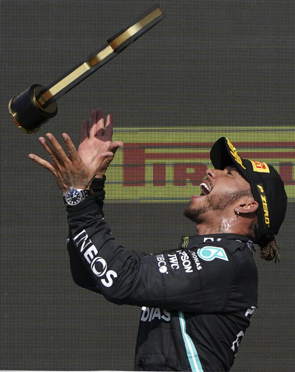 Mercedes driver Lewis Hamilton of Britain celebrates on the podium after winning the British Formula One Grand Prix, at the Silverstone circuit, in Silverstone, England, Sunday, July 18, 2021. (AP Photo/Jon Super)