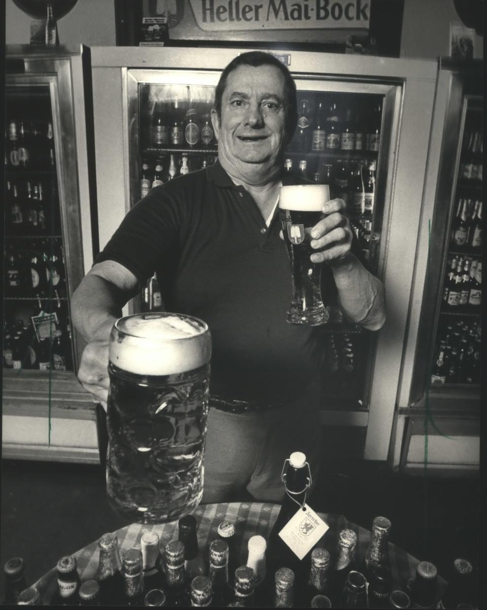 At Zur Krone in Walker's Point, owner Bill Neumann offers a stein of the bar's finest in this 1987 photo. The bar's extensive beer list was one of the biggest in Milwaukee, long before the craft beer movement took hold.